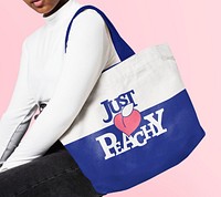 Blue tote bag psd mockup in canvas design with Just Peachy typography