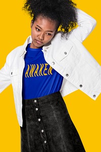 Cool girl in blue t-shirt with AWAKEN typography and white jacket winter apparel shoot