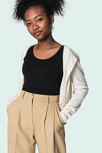Stylish girl in black tee with beige cardigan and trousers youth fashion shoot