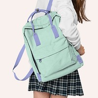 Young girl with green student backpack