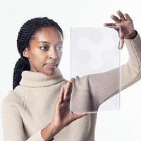 African American woman using transparent digital tablet