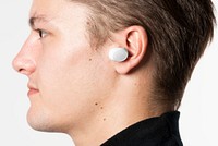 Wireless earbuds in young man&rsquo;s ear