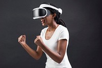 Woman with VR headset cheering with excitement
