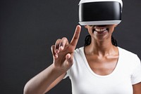 Woman with VR headset touching invisible screen