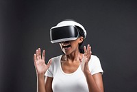 Excited woman with VR headset gaming technology