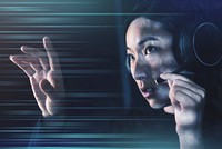 Female operator with headphones touching virtual screen