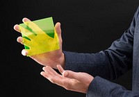 Businessman holding yellow hologram plate