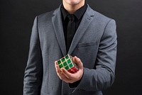 Businessman holding innovative combination puzzle cube 