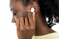 African American woman wearing wireless earbuds