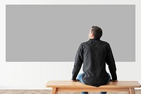 Man with projector wall mockup psd rear view
