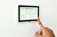 Finger pressing on smart home automation panel monitor