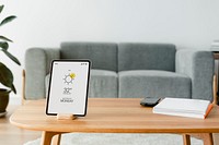 Digital tablet screen mockup psd on a wooden table
