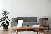 Digital tablet white screen mockup psd on a wooden table