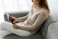 Woman using digital tablet on a couch