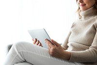 Woman using digital tablet on a couch