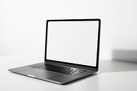 Laptop screen mockup psd on a white table