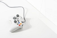 White gaming controller on white floor