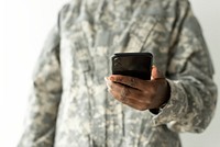 Female soldier using on a smartphone communication technology