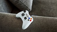 White gaming controller on a sofa