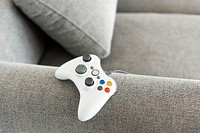 White gaming controller on a sofa