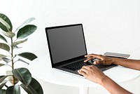 Woman using a laptop with blank screen