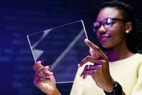 Woman using transparent tablet futuristic technology