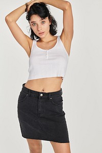 Woman in a black skirt and a white cropped top