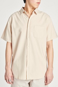 Asian man wearing a beige shirt 