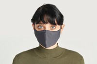 Face mask on a women in a green turtleneck top