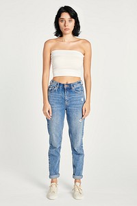 Woman in high-waisted jeans and a white bandeau top 