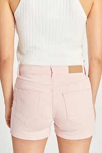 Women&#39;s white crop top and light pink short jeans mockup