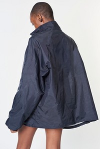 Black woman wearing a navy blue waterproof jacket 