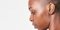 Shaved head black woman side profile