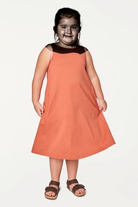 Full body girl wearing orange dress in studio