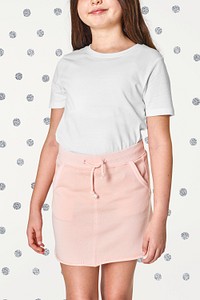Woman's white t-shirt and pink skirt