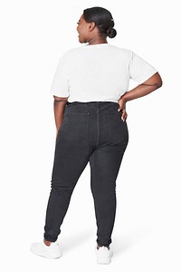 Plus size women&#39;s white tee and jeans fashion studio shot