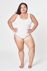 Women's white swimsuit fashion shoot in studio model posing