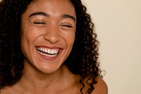 Curly hair woman smiling, beige background