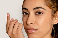 Woman applying lens on eye