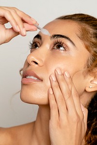 Woman using eye drops