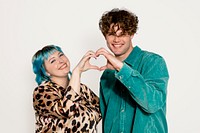 Lovely couple making heart sign with hands