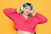 Woman listening to music, isolated on yellow background