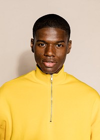 Black man in yellow zip up sweater portrait 