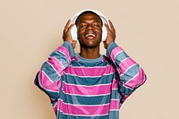 Man listening to music, beige background