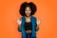 Surprised African American woman on orange background