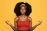 Meditating woman isolated on yellow background
