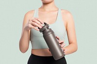Active woman mockup psd holding a stainless steel water bottle