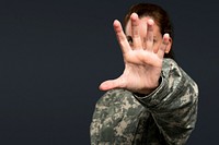 Female soldier reaching out her hand