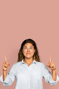 Cheerful woman pointing up and smiling