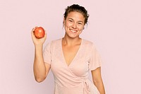 Woman holding apple mockup psd for healthy eating campaign